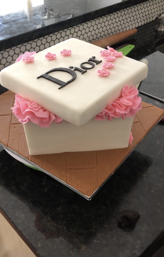 adding a lid to the dior cake box